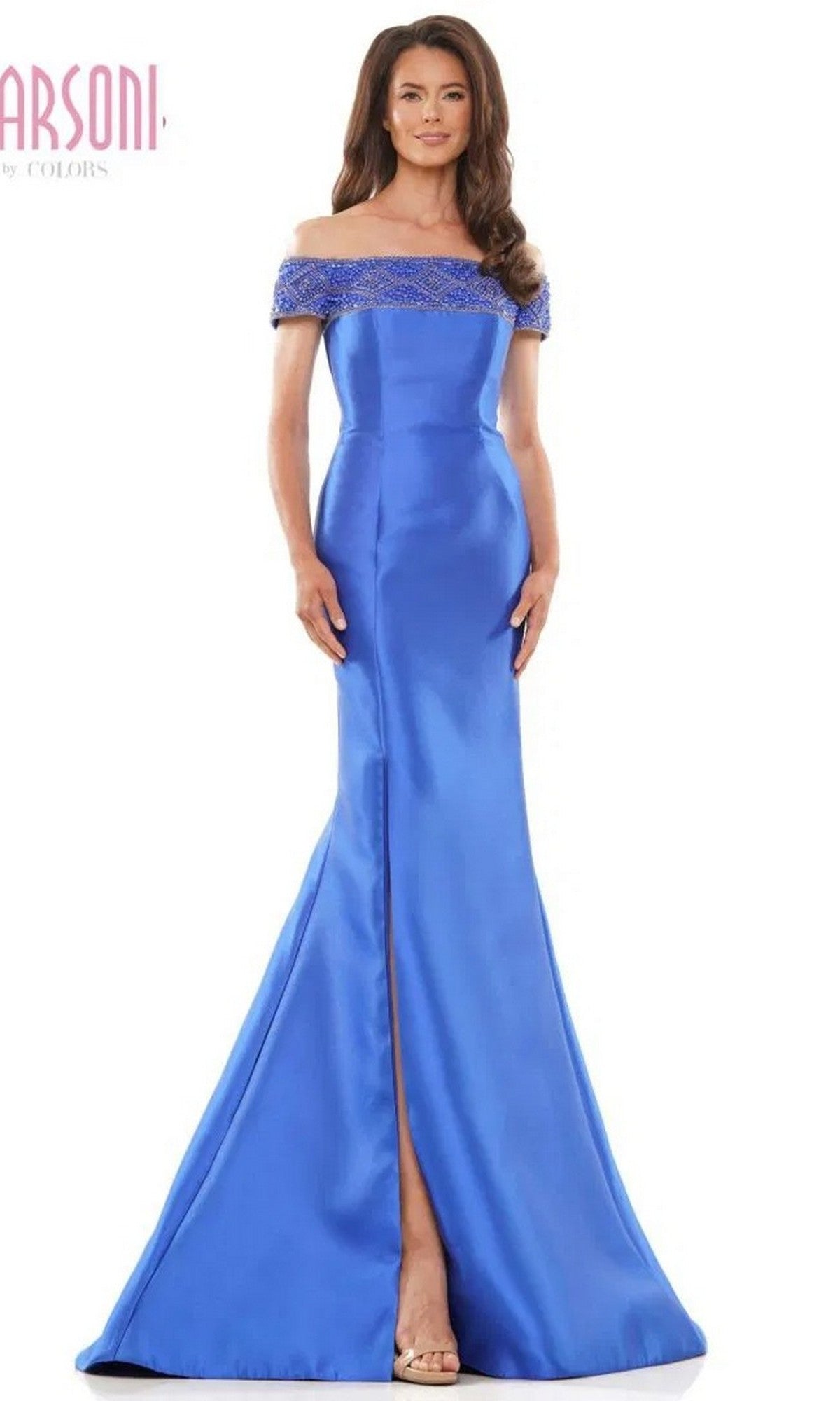 A woman stands with hands by her sides, wearing the Marsoni MV1184 long formal dress in royal—a floor-length, off-the-shoulder gown featuring a mermaid skirt, front slit, and beaded neckline.